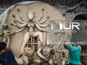 Artisans work on finishing touches of Goddess Durga idols at a workshop in the potter's colony of Tehatta, West Bengal, India, on October 2,...