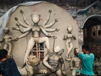 Artisans work on finishing touches of Goddess Durga idols at a workshop in the potter's colony of Tehatta, West Bengal, India, on October 2,...