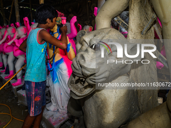 Artisans work on finishing touches of Goddess Durga idols at a workshop in the potter's colony of Tehatta, West Bengal, India, on October 2,...