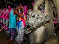 Artisans work on finishing touches of Goddess Durga idols at a workshop in the potter's colony of Tehatta, West Bengal, India, on October 2,...