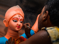 Artisans work on finishing touches of Goddess Durga idols at a workshop in the potter's colony of Tehatta, West Bengal, India, on October 2,...