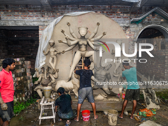 Artisans work on finishing touches of Goddess Durga idols at a workshop in the potter's colony of Tehatta, West Bengal, India, on October 2,...