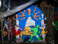 Artisans work on finishing touches of Goddess Durga idols at a workshop in the potter's colony of Tehatta, West Bengal, India, on October 2,...