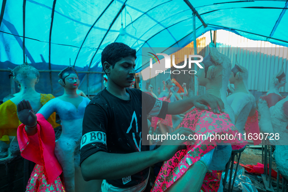 A local artist decorates the idol of Goddess Durga at his studio in Lalitpur, Nepal, on October 2, 2024. Nepal, along with India, celebrates...