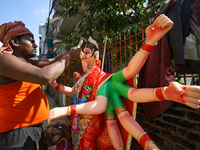 A local artist decorates the idol of Hindu Goddess Durga at his studio in Lalitpur, Nepal, on October 2, 2024. Nepal, along with India, cele...