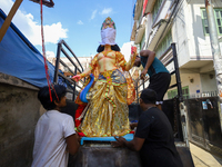 Nepali Hindu devotees load a clay statue of a Hindu deity into a vehicle from a studio in Lalitpur, Nepal, on October 2, 2024. (