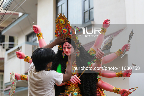 A local artist decorates the idol of Hindu Goddess Durga at his studio in Lalitpur, Nepal, on October 2, 2024. Nepal, along with India, cele...