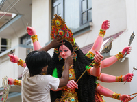 A local artist decorates the idol of Hindu Goddess Durga at his studio in Lalitpur, Nepal, on October 2, 2024. Nepal, along with India, cele...