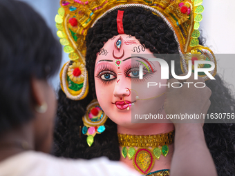 A local artist decorates the idol of Hindu Goddess Durga at his studio in Lalitpur, Nepal, on October 2, 2024. Nepal, along with India, cele...