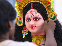 A local artist decorates the idol of Hindu Goddess Durga at his studio in Lalitpur, Nepal, on October 2, 2024. Nepal, along with India, cele...