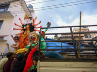 Nepali Hindu devotees load a clay statue of a Hindu deity into a vehicle from a studio in Lalitpur, Nepal, on October 2, 2024. Statues of Go...