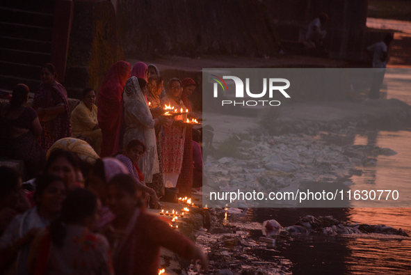 Hindu devotees light diyas on the riverbank of the Mahananda River as part of the prayer of Ganga Aarti and a campaign to save the Mahananda...