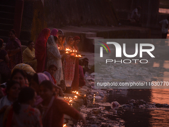 Hindu devotees light diyas on the riverbank of the Mahananda River as part of the prayer of Ganga Aarti and a campaign to save the Mahananda...