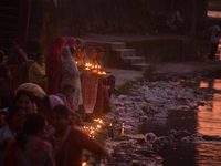 Hindu devotees light diyas on the riverbank of the Mahananda River as part of the prayer of Ganga Aarti and a campaign to save the Mahananda...