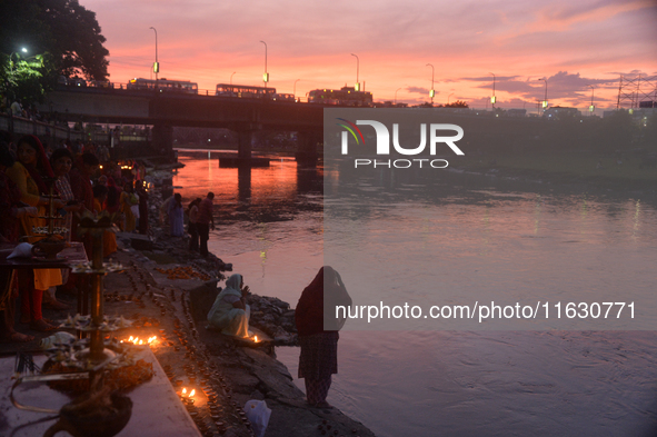 Hindu devotees light diyas on the riverbank of the Mahananda River as part of the prayer of Ganga Aarti and a campaign to save the Mahananda...