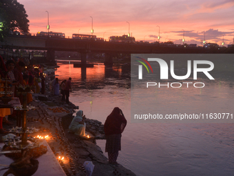 Hindu devotees light diyas on the riverbank of the Mahananda River as part of the prayer of Ganga Aarti and a campaign to save the Mahananda...