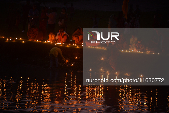 Hindu devotees light diyas on the riverbank of the Mahananda River as part of the prayer of Ganga Aarti and a campaign to save the Mahananda...