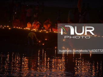 Hindu devotees light diyas on the riverbank of the Mahananda River as part of the prayer of Ganga Aarti and a campaign to save the Mahananda...