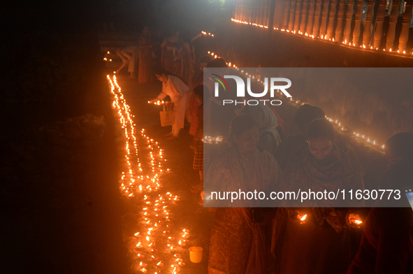 Hindu devotees light diyas on the riverbank of the Mahananda River as part of the prayer of Ganga Aarti and a campaign to save the Mahananda...