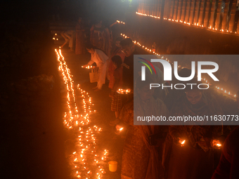 Hindu devotees light diyas on the riverbank of the Mahananda River as part of the prayer of Ganga Aarti and a campaign to save the Mahananda...