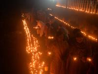 Hindu devotees light diyas on the riverbank of the Mahananda River as part of the prayer of Ganga Aarti and a campaign to save the Mahananda...