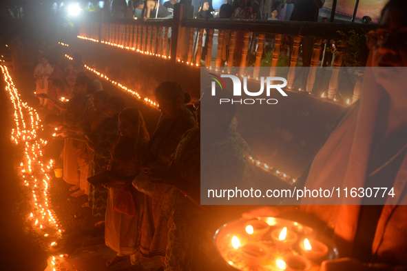 Hindu devotees light diyas on the riverbank of the Mahananda River as part of the prayer of Ganga Aarti and a campaign to save the Mahananda...