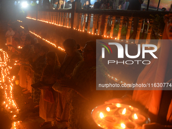 Hindu devotees light diyas on the riverbank of the Mahananda River as part of the prayer of Ganga Aarti and a campaign to save the Mahananda...