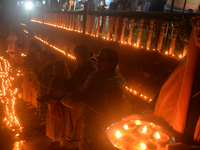 Hindu devotees light diyas on the riverbank of the Mahananda River as part of the prayer of Ganga Aarti and a campaign to save the Mahananda...