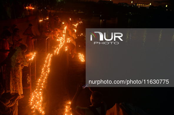 Hindu devotees light diyas on the riverbank of the Mahananda River as part of the prayer of Ganga Aarti and a campaign to save the Mahananda...