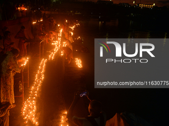 Hindu devotees light diyas on the riverbank of the Mahananda River as part of the prayer of Ganga Aarti and a campaign to save the Mahananda...