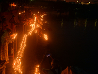 Hindu devotees light diyas on the riverbank of the Mahananda River as part of the prayer of Ganga Aarti and a campaign to save the Mahananda...