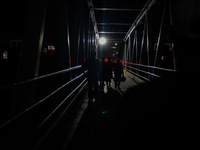 Individuals make their way back to their residences following a day of work in Baramulla, Jammu and Kashmir, India, on October 2, 2024. (