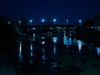 Vehicles move on a bridge as street lights glow during an evening in Baramulla, Jammu and Kashmir, India, on October 2, 2024. (