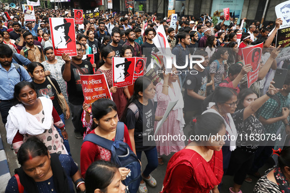 Doctors and citizens hold placards and shout slogans during a protest march against the rape and murder of a PGT woman doctor at Government-...