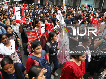 Doctors and citizens hold placards and shout slogans during a protest march against the rape and murder of a PGT woman doctor at Government-...