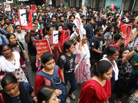 Doctors and citizens hold placards and shout slogans during a protest march against the rape and murder of a PGT woman doctor at Government-...