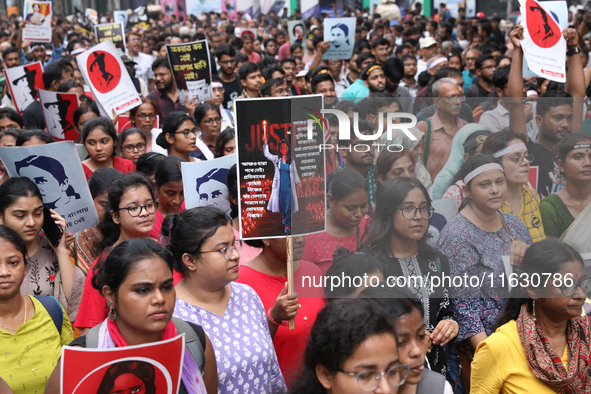 Doctors and citizens hold placards and shout slogans during a protest march against the rape and murder of a PGT woman doctor at Government-...