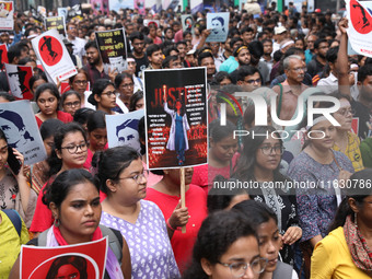 Doctors and citizens hold placards and shout slogans during a protest march against the rape and murder of a PGT woman doctor at Government-...