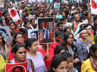 Doctors and citizens hold placards and shout slogans during a protest march against the rape and murder of a PGT woman doctor at Government-...