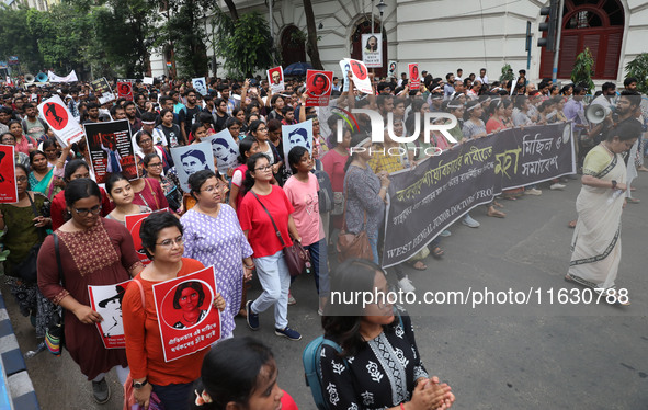 Doctors and citizens hold placards and shout slogans during a protest march against the rape and murder of a PGT woman doctor at Government-...