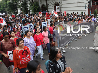 Doctors and citizens hold placards and shout slogans during a protest march against the rape and murder of a PGT woman doctor at Government-...