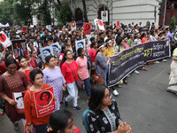 Doctors and citizens hold placards and shout slogans during a protest march against the rape and murder of a PGT woman doctor at Government-...