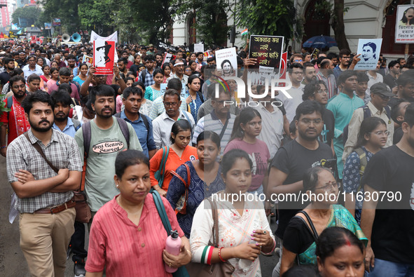 Doctors and citizens hold placards and shout slogans during a protest march against the rape and murder of a PGT woman doctor at Government-...