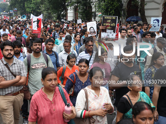 Doctors and citizens hold placards and shout slogans during a protest march against the rape and murder of a PGT woman doctor at Government-...