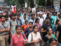 Doctors and citizens hold placards and shout slogans during a protest march against the rape and murder of a PGT woman doctor at Government-...