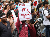 Doctors and citizens hold placards and shout slogans during a protest march against the rape and murder of a PGT woman doctor at Government-...