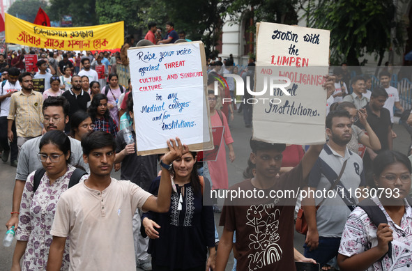 Doctors and citizens hold placards and shout slogans during a protest march against the rape and murder of a PGT woman doctor at Government-...