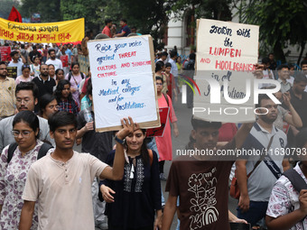 Doctors and citizens hold placards and shout slogans during a protest march against the rape and murder of a PGT woman doctor at Government-...