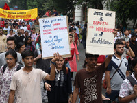 Doctors and citizens hold placards and shout slogans during a protest march against the rape and murder of a PGT woman doctor at Government-...