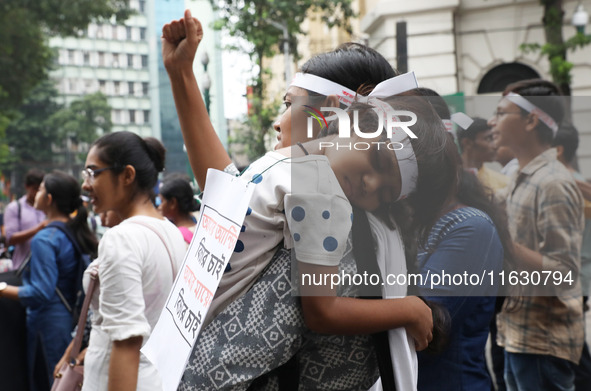 Doctors and citizens hold placards and shout slogans during a protest march against the rape and murder of a PGT woman doctor at Government-...